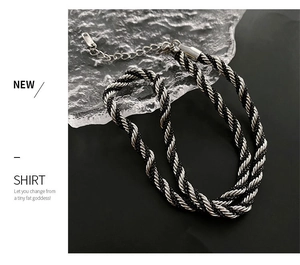Detail of twisted black cord and silver metal chain necklace with lobster clasp closure