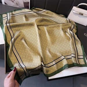 Elegant 70cm silk-like scarf with green geometric Greek pattern in a tray display