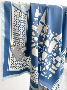Detailed close-up of fashion silk scarf showing elegant blue and white accessory prints