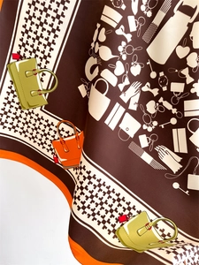 Detail of silk square scarf featuring houndstooth pattern and handbag illustrations