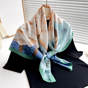 Elegant 90cm silk-satin scarf with abstract floral painting tied on a black sweater