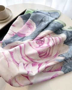 Macro view of silky satin scarf featuring purple rose prints and green marble textures