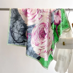Detail of floral silk scarf showing large pink roses and green texture on twill fabric