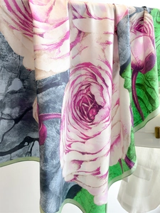 Detailed view of the soft silk-like fabric with elegant rose floral patterns and fluid folds
