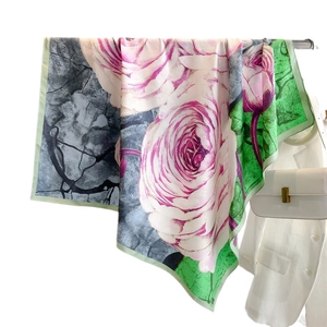 90cm luxury rose flower silk scarf with contrast green border draped on a rack