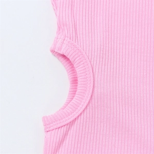 Close-up of pink ribbed knit fabric showing circular side cut-out detail and stitching