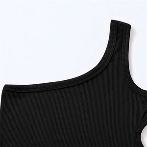 Detailed view of black ribbed knit fabric and reinforced seams on girls one-shoulder tank top