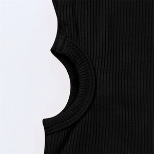Detail of black ribbed knit fabric showing circular waist cutout and fine stitching