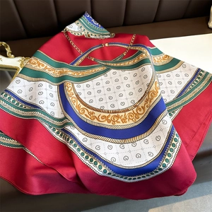 Elegant 90cm silk scarf with gold chain and floral patterns on leather background