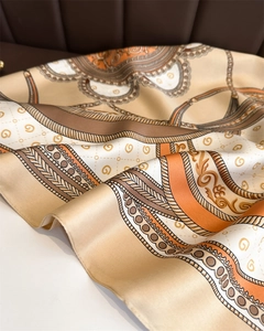 Detailed close-up of retro chain pattern and silk texture on orange square scarf