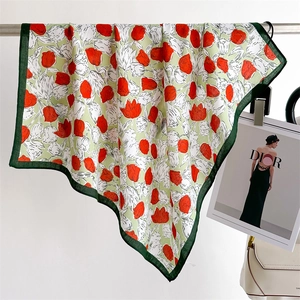 Detail of red tulip pattern silk scarf hanging elegantly with a green border finish