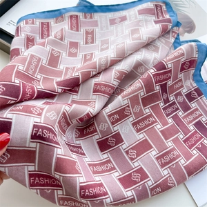 Close-up of vintage silk scarf with red weave pattern and light blue rolled edges
