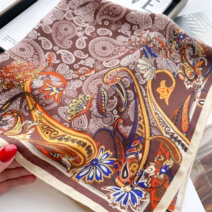 Luxurious paisley silk scarf with bohemian floral patterns and elegant rolled edges