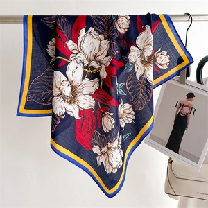 Elegant navy blue silk scarf with white lily floral print and contrasting yellow border
