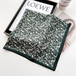 Detail of floral silk scarf with vintage green flower pattern on a stylish setting
