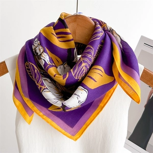 Elegant purple lily flower print silk scarf tied on a hanger with a stylish pattern