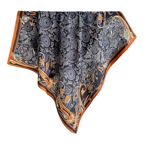 Luxurious paisley silk scarf for women featuring a black pattern and orange border