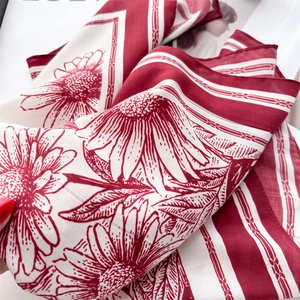 Detail of vintage burgundy sunflower silk scarf with striped borders and fine texture