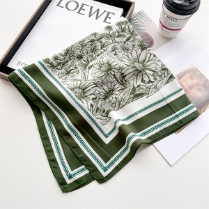 Vintage floral silk square scarf in dark green and beige, elegantly displayed with props