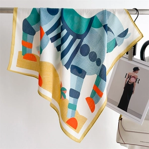 Silk square scarf with geometric horse print and orange borders on a fashion display