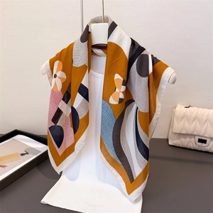 Close-up of abstract geometric floral print scarf styled with elegant white outfit and accessories
