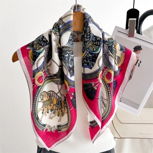 Detail shot of equestrian silk scarf featuring chain patterns and pink border on a mannequin