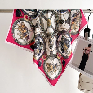 Detail of vintage silk scarf with golden chain and horse carriage print on ivory base