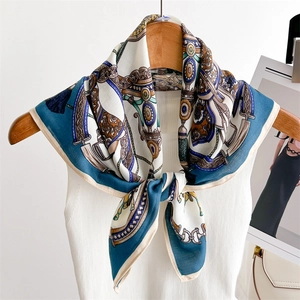 Retro silk scarf with horse carriage and chain print hanging on a white knit vest