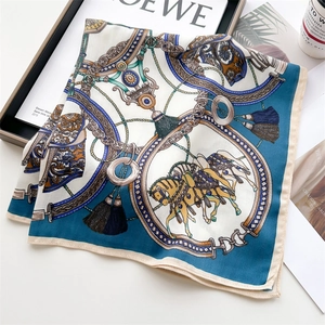 Detailed flat lay of horse and gold chain print silk scarf with refined rolled edges