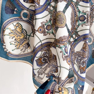 Detailed close-up showing the elegant equestrian chain print on a silky square scarf
