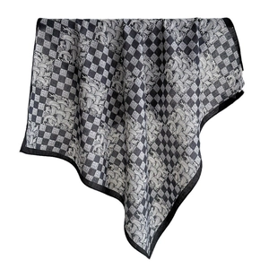 Luxurious black and white houndstooth silk scarf with retro swirl pattern on white background