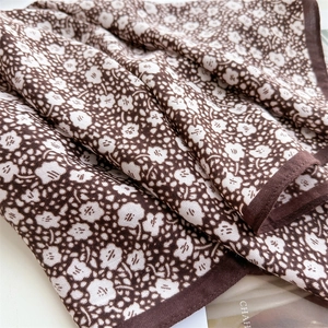 Floral print silk scarf in brown with white patterns and delicate hemmed edges