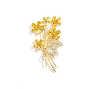 Elegant floral bouquet brooch with yellow teardrop gems and red crystal center accent