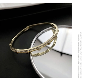 Close-up of golden adjustable zircon bracelet featuring polished finish and rhinestones
