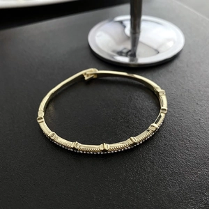 Elegant gold-tone adjustable zircon bracelet featuring textured relief and a clasp closure