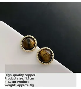 Detail view of vintage tiger eye button earrings with gold rope border and 1.7cm size