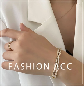 Detail of elegant gold crossover bracelet with rows of sparkling cubic zirconia stones