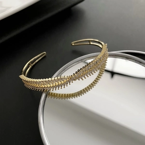 Luxurious gold-tone crisscross open cuff bracelet with micro-pave white zircon stones