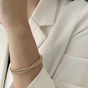 Elegant gold-plated crisscross open bangle featuring double rows of sparkling cubic zirconia