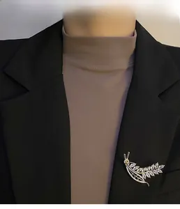 Detailed view of wheat spike brooch with zircons pinned on a black suit jacket
