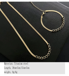 Detail of titanium steel flat snake chain with sparkling green round cut gemstone