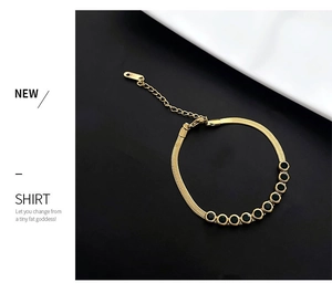 Detail of adjustable gold snake chain bracelet with ten round black zircon gemstones