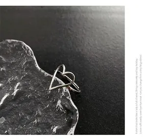 Détail de la bague coeur argentée sur un bloc de glace avec des textures métalliques