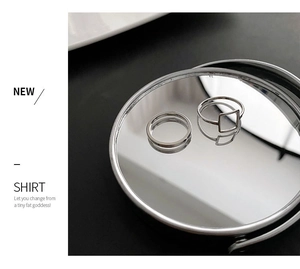 Detail shot of two minimalist geometric silver rings featuring a square hollow design