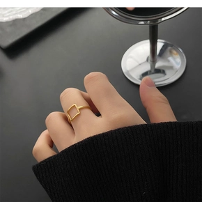 Minimalist square hollow geometric ring in gold finish worn on a finger for a chic style