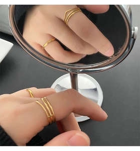 Close-up of a two-piece gold titanium ring set with a geometric multilayer design