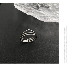 Macro view showing the detailed double-layer geometric design of silver titanium steel ring