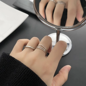 Minimalist silver stackable ring set in stainless steel worn by a model