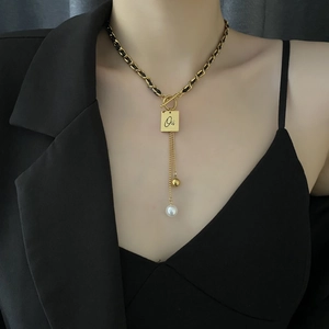 Fashionable gold tassel necklace with square letter pendant and pearl on leather chain