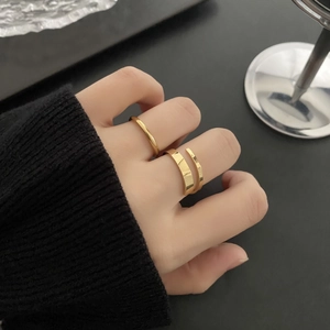 Polished gold minimalist stackable rings including an adjustable wide band and slim band